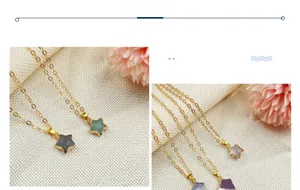 Star-shaped gemstone necklaces in five colors with golden chains on a beige fabric