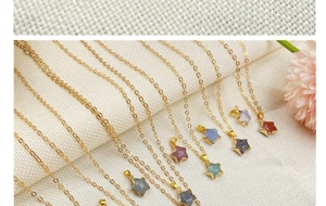 Detailed view of colorful star-shaped gemstone necklaces on a textured fabric background