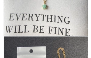 Detail of light green star pendant necklace with gold chain on display card