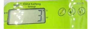 Detail of green kitchen scale LCD screen with g/oz unit display and physical buttons