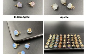 Makroaufnahme von facettierten Amethyst-Anhängern mit vergoldeten Metallkappen