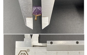 Macro detail of hexagonal amethyst pendant size measurement using a caliper tool