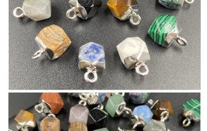 Close-up of faceted crystal stone pendants in malachite, tiger eye, and rose quartz
