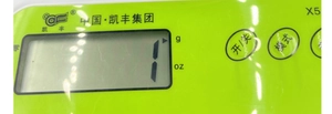 Macro detail of a green electronic kitchen scale control panel with LCD digital display