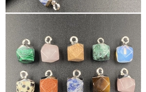 Macro detail of faceted gemstone pendants in various colors with silver metal loops