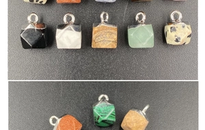 Detailed view of faceted semi-precious stone charms with silver loops for jewelry DIY