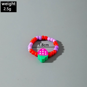Detailed shot of handmade colorful beaded ring with a pink strawberry charm and 1.8cm size