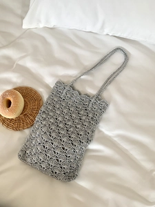 Detailed close-up of handmade crochet silver tote bag with hollow scalloped pattern