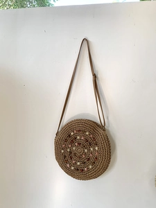 Handmade round straw shoulder bag with colorful beads and adjustable strap for beach vacation