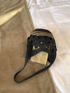Détail du sac cabas au crochet noir avec rayures kaki et motifs de fleurs évidés