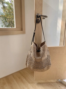 Detail of bohemian woven beach bag with hollow mesh patterns and round floral textures