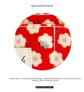 Détail du tissu floral rouge en coton avec revêtement imperméable et coutures