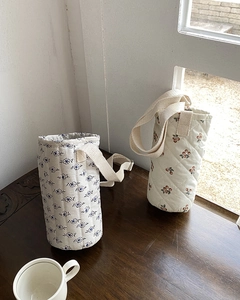 Detailed close-up of quilted cotton water bottle bags with floral and berry patterns