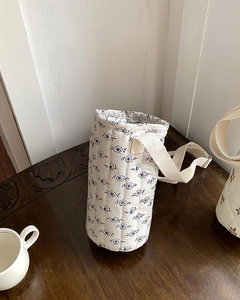 Quilted floral water bottle bag with adjustable shoulder strap and thermal lining