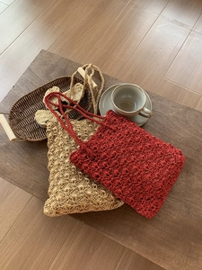Detailed close-up of handmade woven bags with intricate crochet texture in gold and red