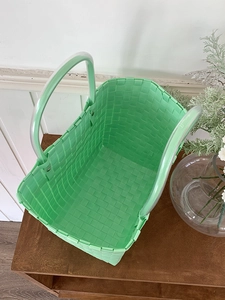 Close-up of hand-woven mint green beach bag with double transparent soft handles