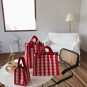 Detailed set of three red checkered canvas tote bags in small, medium, and large sizes