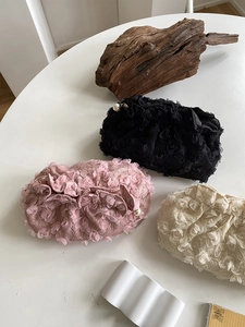Detail of 3D floral lace clutch with pearl zipper pull in black pink and cream