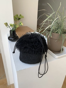 Detail einer handgewebten schwarzen Beuteltasche mit Tüll-Spitzenbesatz und Kordelzug