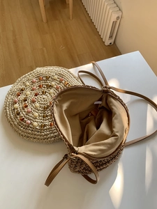 Handcrafted round straw crossbody bag with colorful beads and slim leather shoulder strap