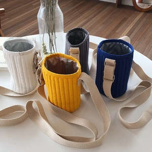 Detailed group view of four quilted insulated water bottle bags with canvas shoulder straps