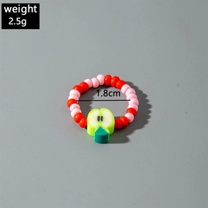 Detail of colorful beaded fruit ring showing a green apple charm and 1.8cm diameter size