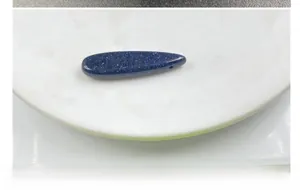 Macro detail of blue sandstone teardrop pendant with starry shimmer and top-drilled hole