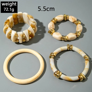 Detail of 4pcs set acrylic bracelets featuring marble patterns and gold metal accents