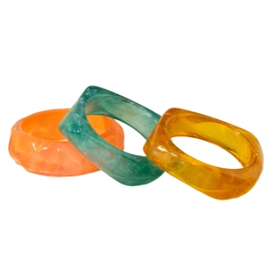 Three-piece set of chunky resin bangles featuring colorful translucent geometric designs