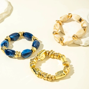 Detail of chunky acrylic marble effect beads and irregular gold metal bracelet accents