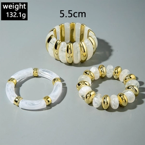Detailed view of chunky acrylic marble beads and gold metal bracelets weighing 132.1g
