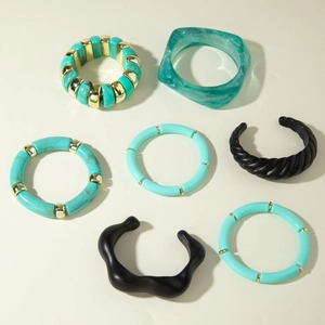 Detail of 7-piece bohemian bracelet set with resin beads and gold-tone metal bangles