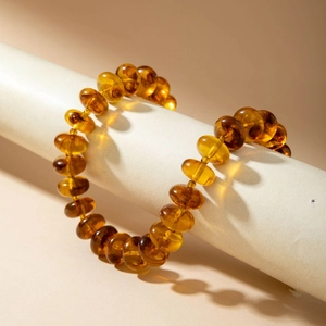Macro view of translucent honey yellow acrylic beads with smooth glossy finish