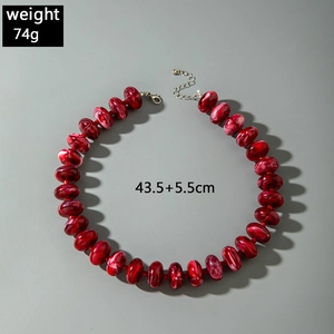 Chunky red acrylic bead necklace with marble texture and adjustable lobster clasp closure