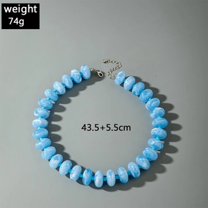 Detailed view of colorful acrylic beaded necklace with silver lobster clasp and sizing
