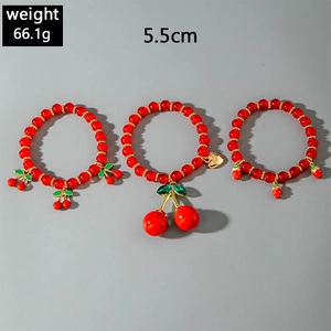 Detailed view of red cherry and strawberry beaded bracelets with weight and size info