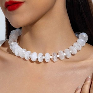 Detail of colorful translucent white acrylic bead necklace with cloudy texture on a model