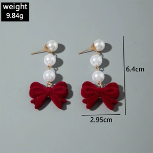 Detail view of red velvet bow earrings with three white pearls showing dimensions and weight