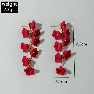 Detail shot of red velvet flower drop earrings with golden chain and 7.2cm length