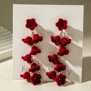 Detail of vintage red velvet flower long tassel earrings with golden chain link