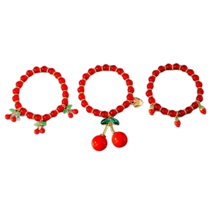 Stackable red beaded cherry and strawberry charm bracelets with golden heart accents