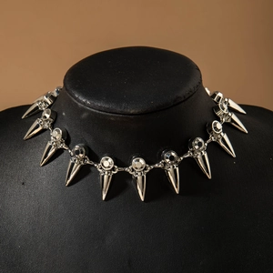 Punk silver spike necklace with clear crystals on a black mannequin display