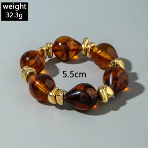Detail of amber resin drop beads with gold metal spacers and 32.3g weight display