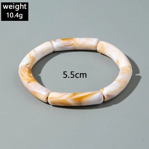 Detail view of amber and white marble acrylic bangle with 5.5cm inner diameter