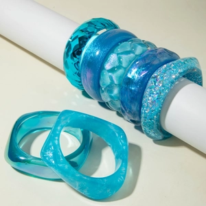 Various blue glitter resin bangles with glitter and geometric textures for women