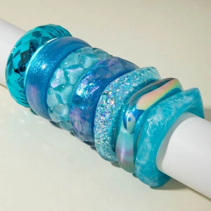 Blue resin bracelets set with glitter heart charms and sparkling facet textures