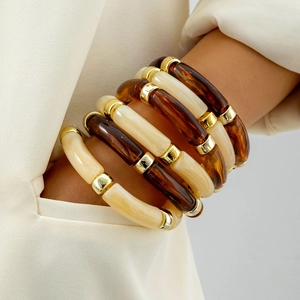 Retro acrylic tube bracelet set with amber resin beads and gold accents on model