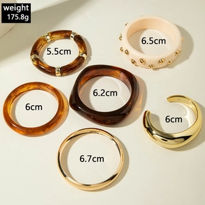 Flat lay of resin and metal bangles showing inner diameters from 5.5cm to 6.7cm