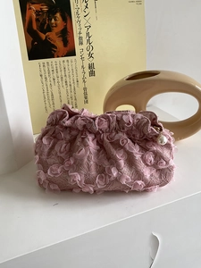Detail of pink lace floral cosmetic bag with elegant pearl zipper pendant decoration