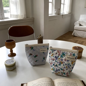 Détail de trousses à maquillage matelassées en coton avec motifs fleurs et animaux